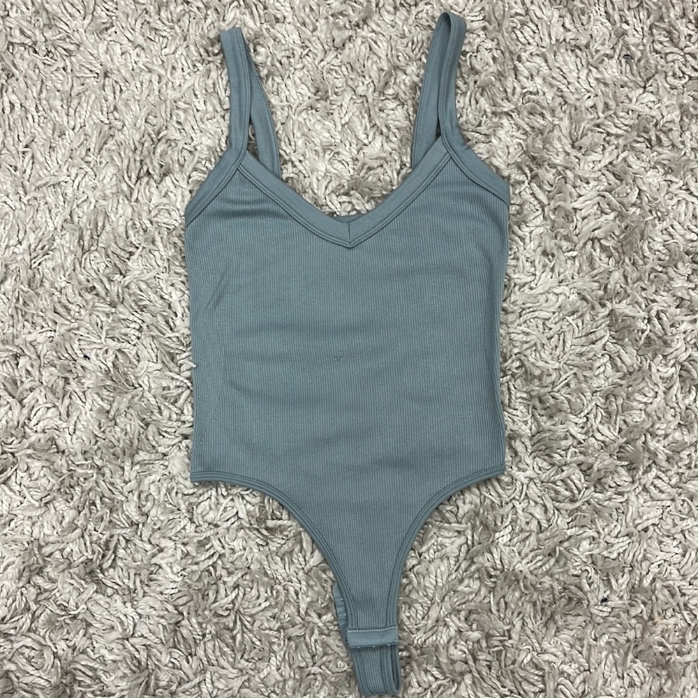 Light blue ribbed bodysuit.